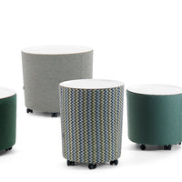 Colorful round storage tables featuring gray, green, and a zigzag patterned fabric. Perfect for modern decor.
