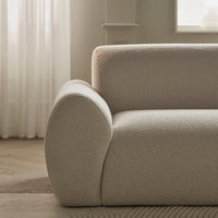 Textured beige fabric sofa with a soft, rounded armrest and subtle pattern, perfect for modern interiors.