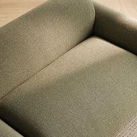 Olive green textured upholstery on a modern sofa, showcasing subtle patterns and a cozy, inviting look.