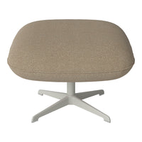 Beige tufted ottoman with a soft texture and a sleek white base, ideal for modern decor.