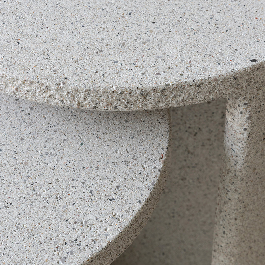 Gray speckled stone surface with a textured finish, featuring subtle hints of varied colors throughout.