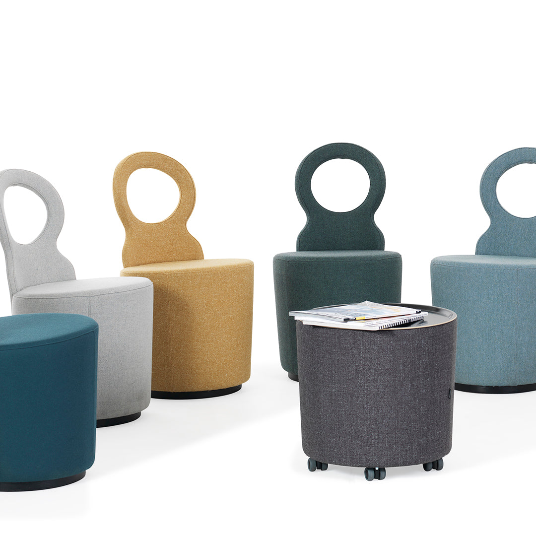 Colorful modern chairs in gray, mustard, teal, and green patterns with a gray rolling table.