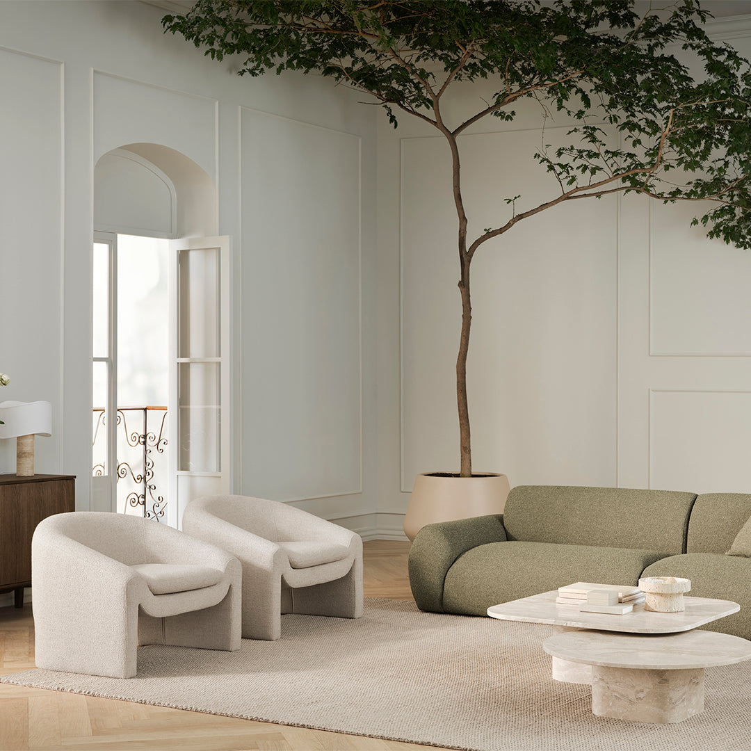 Soft beige and muted green seating with textured patterns in a cozy, light-filled modern living space.