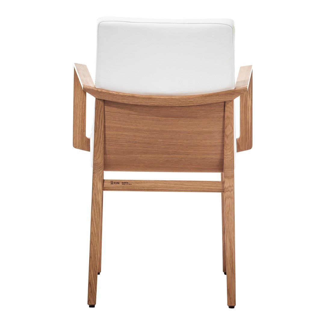 White upholstered chair with a natural wood frame, showcasing a minimalist design and clean lines.