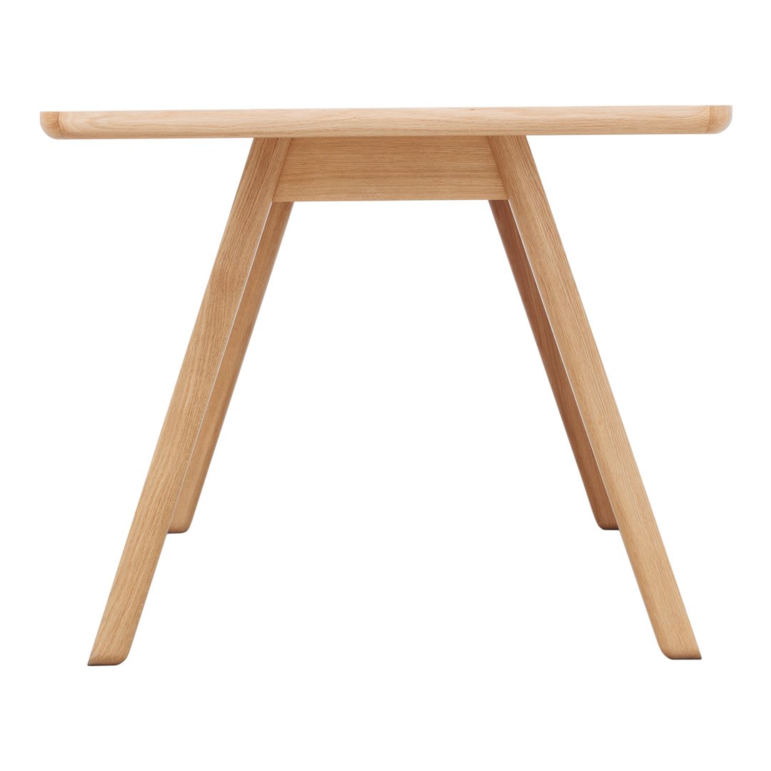 Natural wood table with light oak finish and minimalistic, modern design. Clean lines and simple shape.