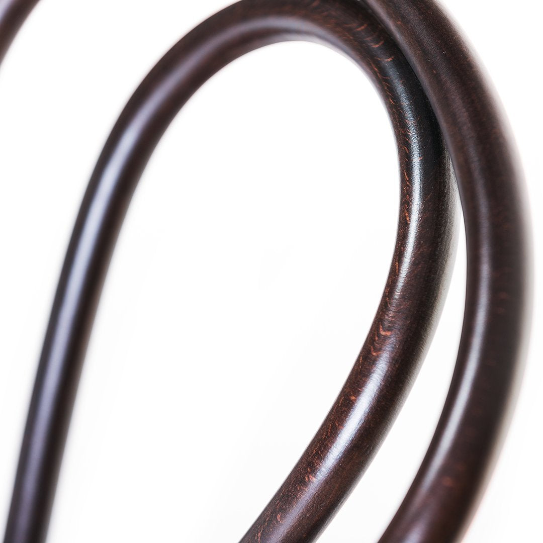 Brown curved wood grain pattern with smooth, glossy finish on a white background. Ideal for modern decor.