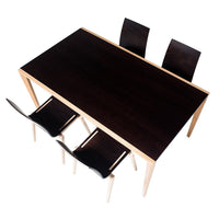 Modern dark brown dining table with sleek light wooden legs, accompanied by three matching black chairs.