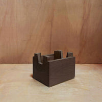 Dark brown wooden box with a minimalist design, featuring clean lines and a smooth finish. Ideal for modern decor.
