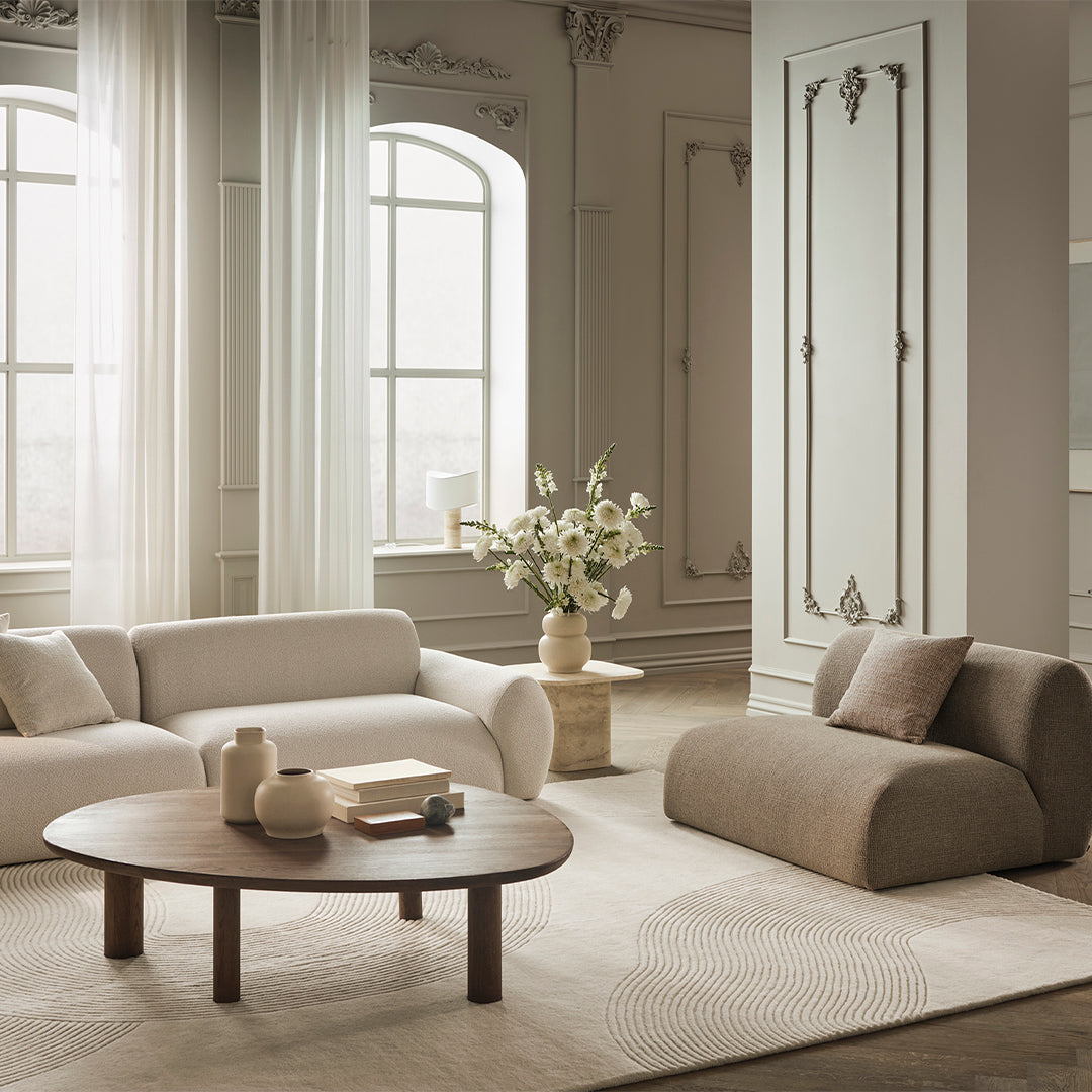 Neutral beige and soft white colors with subtle textured patterns in a minimalist living room setting.
