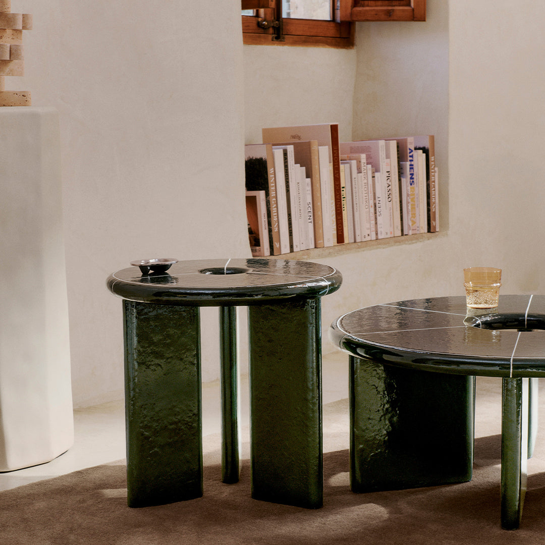 Glossy black and deep green side tables with textured finishes, featuring contrasting circular and rectangular patterns.