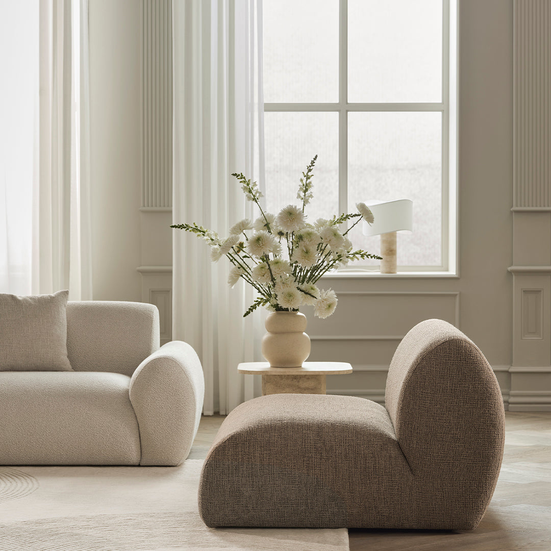 Beige and gray contemporary sofa set with textured fabric against a soft, neutral-toned interior.