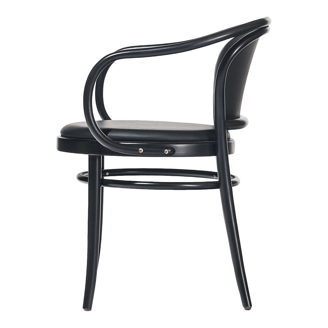 Black curved armchair with sleek design, featuring a smooth surface and minimalist aesthetic. 