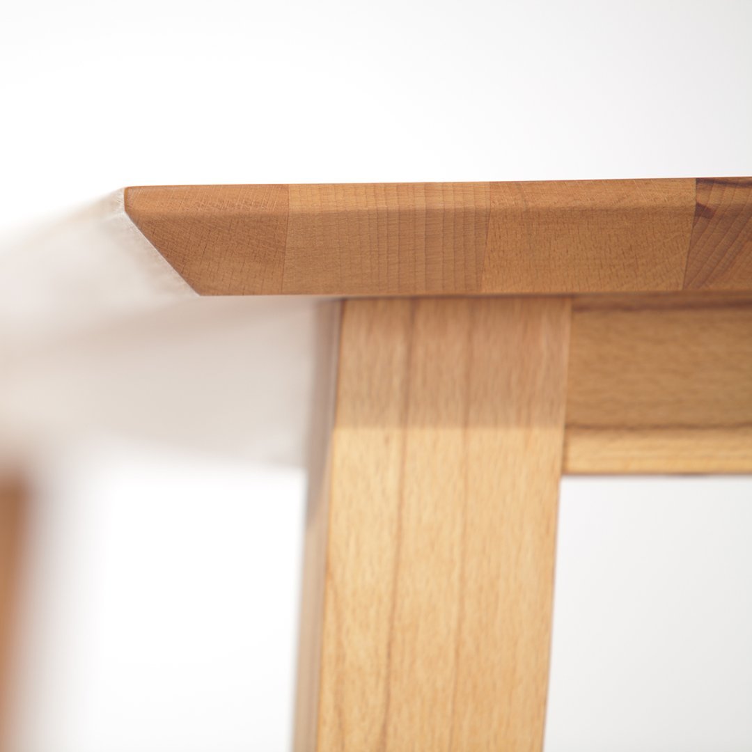 Light wood table showcasing natural grain patterns with a smooth, polished finish. Ideal for minimalistic decor.