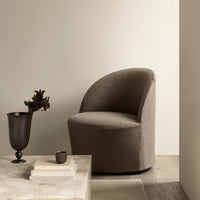 Brown upholstered chair with a curved design, set against neutral tones and a textured surface. Perfect for modern decor.
