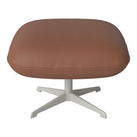 Brown leather ottoman with a smooth texture and a minimalist white base, perfect for modern interiors.