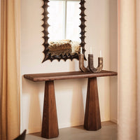 Wooden console table in rich brown with a textured dark mirror and soft beige curtains. Simple yet elegant design.