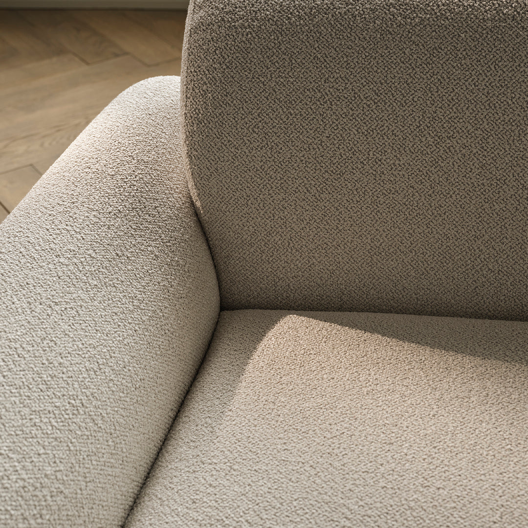 Beige textured upholstery with subtle patterns, showcasing a soft and cozy appearance for modern decor.