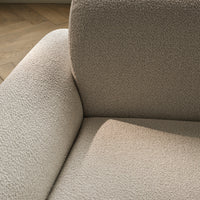 Beige textured upholstery with subtle patterns, showcasing a soft and cozy appearance for modern decor.