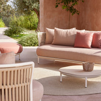Stylish outdoor seating in soft pink and earthy tones with textured patterns. Perfect for garden or patio decor.