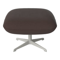 Brown upholstered ottoman with a smooth texture and a subtle speckled pattern, featuring a sleek white base.