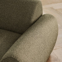 Textured olive green upholstery on rounded chair arm, showcasing a subtle, woven pattern.