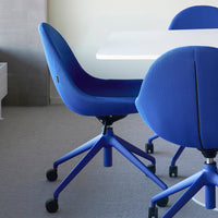 Blue mesh office chairs with textured patterns and a matching blue base, positioned around a white table.