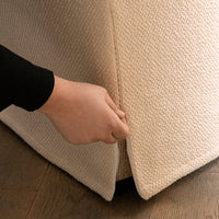 Beige textured fabric with a woven pattern, showcasing a cozy, neutral aesthetic perfect for home decor.