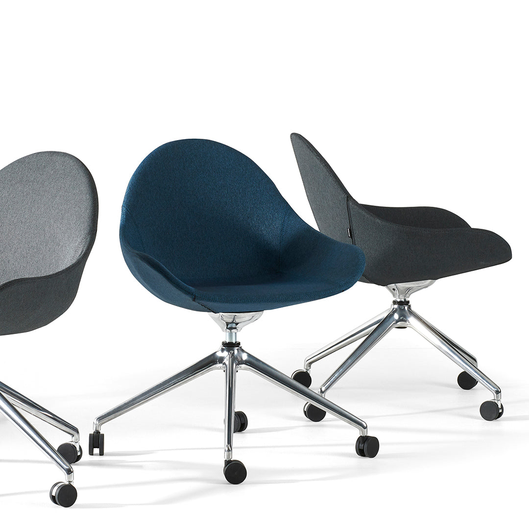 "Three modern chairs in dark gray, rich blue, and soft charcoal upholstery with chrome bases, showcasing sleek patterns."