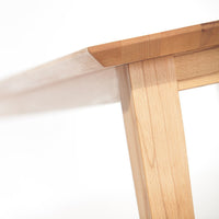 Light wood table with a smooth, natural finish and clean lines, showcasing warm maple tones and minimal patterns.