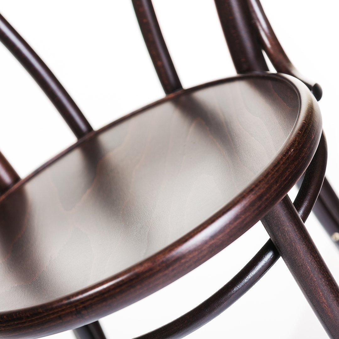 Dark brown wooden chair with a smooth, polished circular seat and elegant curved legs. Modern and stylish design.