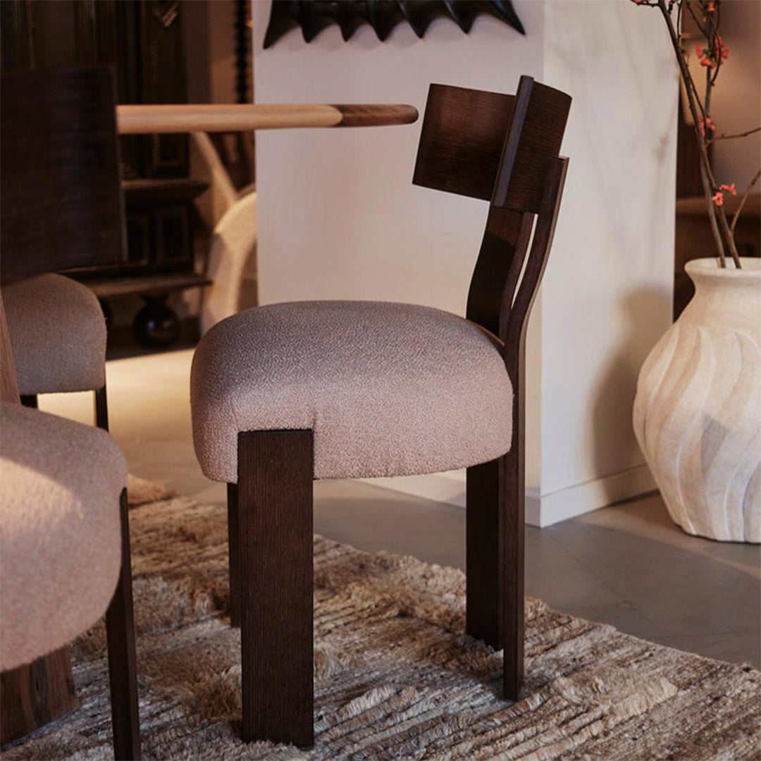 Stylish chair with a soft beige fabric seat and dark wood legs, featuring a textured finish and modern geometric design.