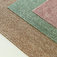 Textured woven rugs in earthy brown, soft green, and muted red patterns, perfect for any stylish space.