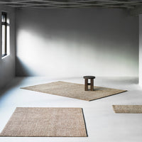 Natural beige area rugs with woven textures, enhancing minimalist spaces. Perfect for neutral decor.