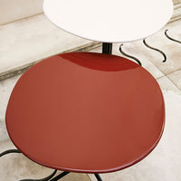 Red and white glossy tabletop with curved edges, set against a neutral tile background. Ideal for modern decor.