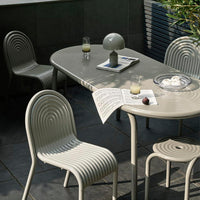 Light gray dining set with textured, ribbed patterns on chairs and table, creating a modern and stylish look.
