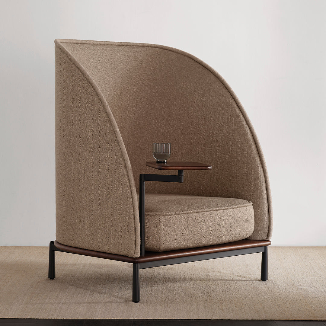 Beige upholstered chair with curved sides and a wooden side table, featuring a soft texture and modern design.