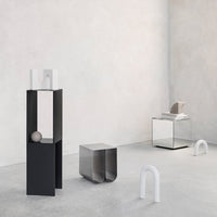 Modern furniture in black, white, and metallic finishes, featuring sleek geometric shapes and minimalistic patterns.