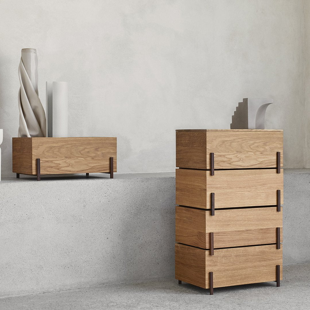 Minimalist oak dressers with natural wood grain and sleek lines against a light grey background.