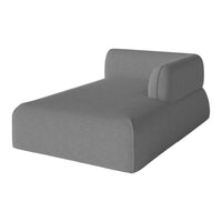 Gray upholstered chaise lounge with a sleek, minimalist design and a rounded armrest. Perfect for modern decor.