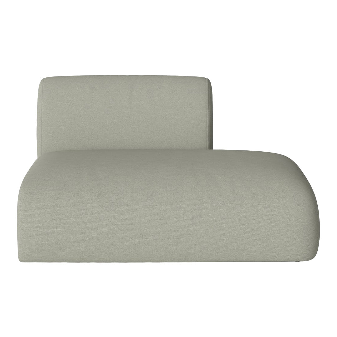 Soft green lounge chair with a smooth, minimalist design and a seamless, solid fabric texture.