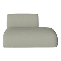 Soft green lounge chair with a smooth, minimalist design and a seamless, solid fabric texture.