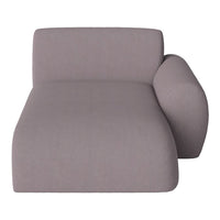 Modern chaise lounge in soft gray fabric with smooth, minimalist design and rounded armrest. Ideal for stylish decor.