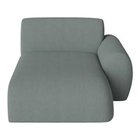 Modern chaise lounge in soft, muted gray upholstery, featuring a sleek, minimalist design and rounded armrest.