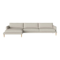 Light beige sectional sofa with soft cushions and minimalist design, featuring natural wood legs for a cozy look.