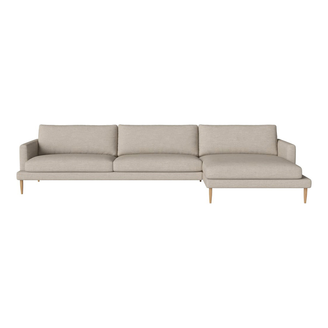 Light beige sectional sofa with a smooth, minimalist design and wooden legs, perfect for modern interiors.