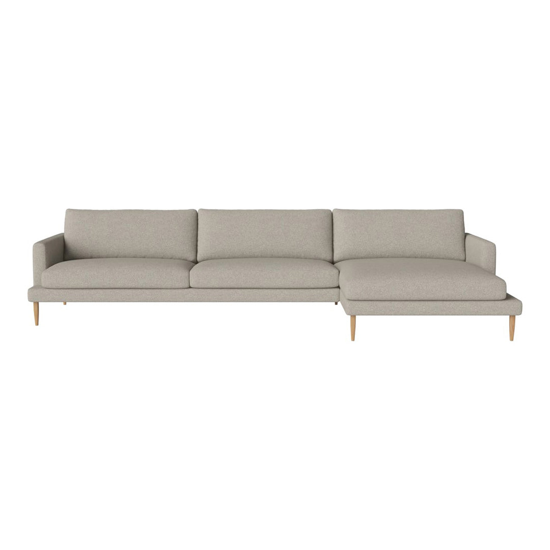 Light gray sectional sofa with clean lines and a subtle texture, featuring wooden legs for a modern look.
