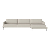 Light beige sectional sofa with smooth, minimalist design and plush cushions on a sleek silver base.