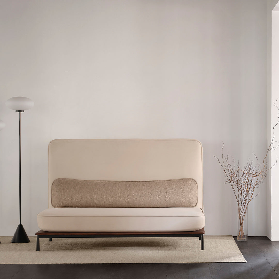 Beige and light brown sofa with a smooth texture, complemented by a dark wood base and minimalistic design.