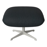 Black textured fabric ottoman with a sleek white metal base, ideal for modern decor.