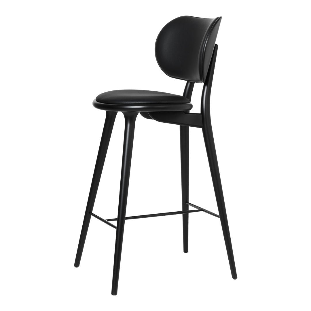 Sleek black bar stool with a smooth, curved seat and backrest, featuring minimalistic design and clean lines.